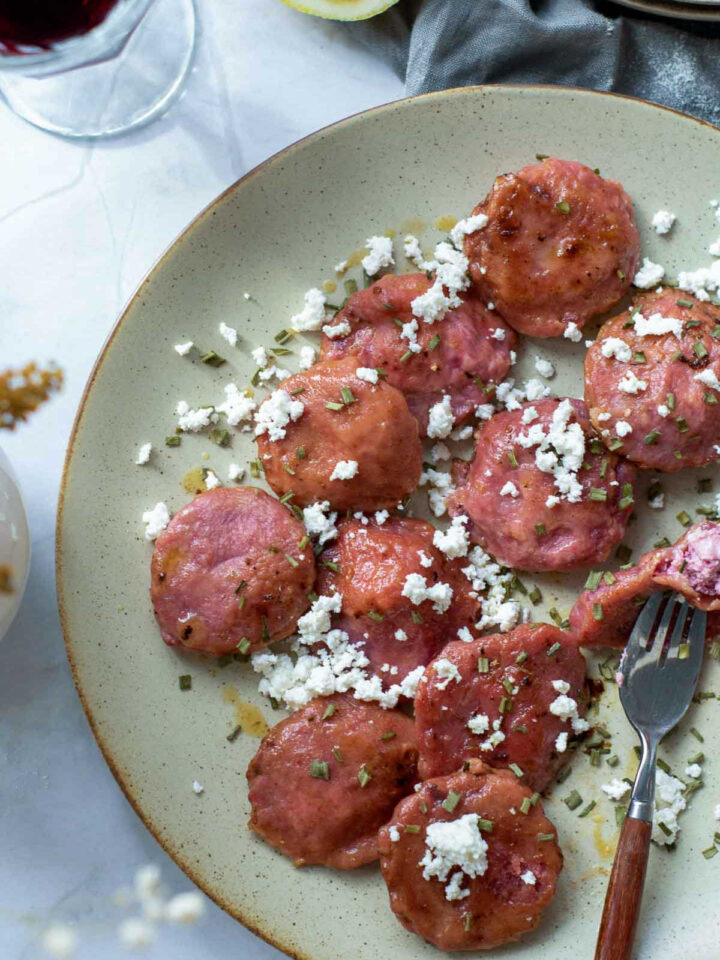Close up of a plate of beet ravioli.