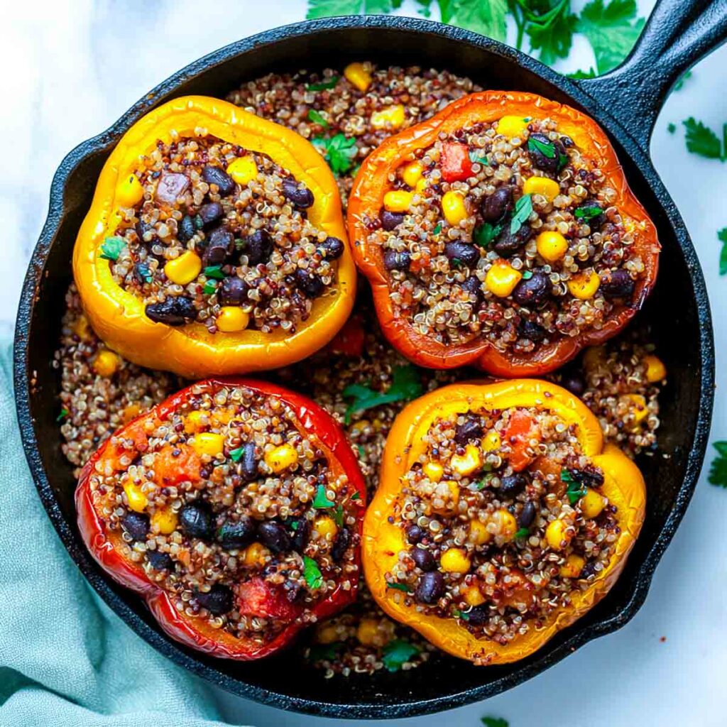 Peppers stuffed with quinoa and black beans and cooked on a skillet.