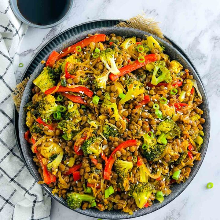 A big bowl of broccoli and lentil stir fry placed in grey bowl.