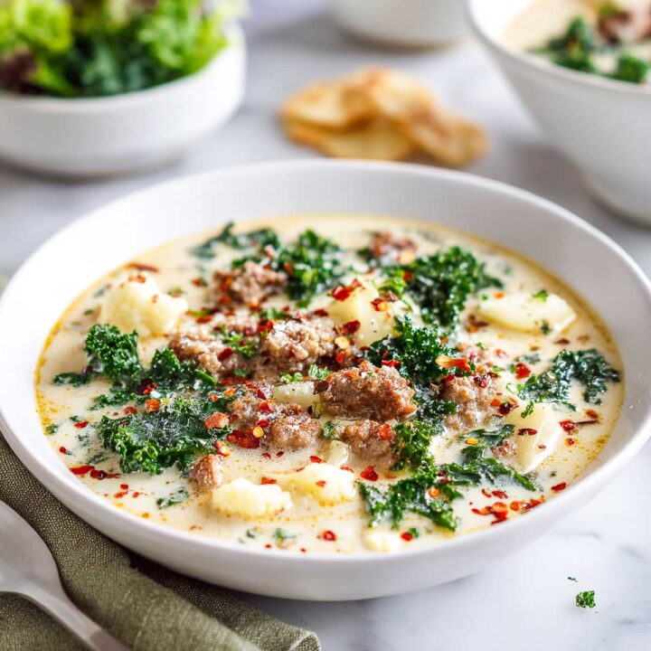 Crockpot zuppa toscana served in a white bowl.