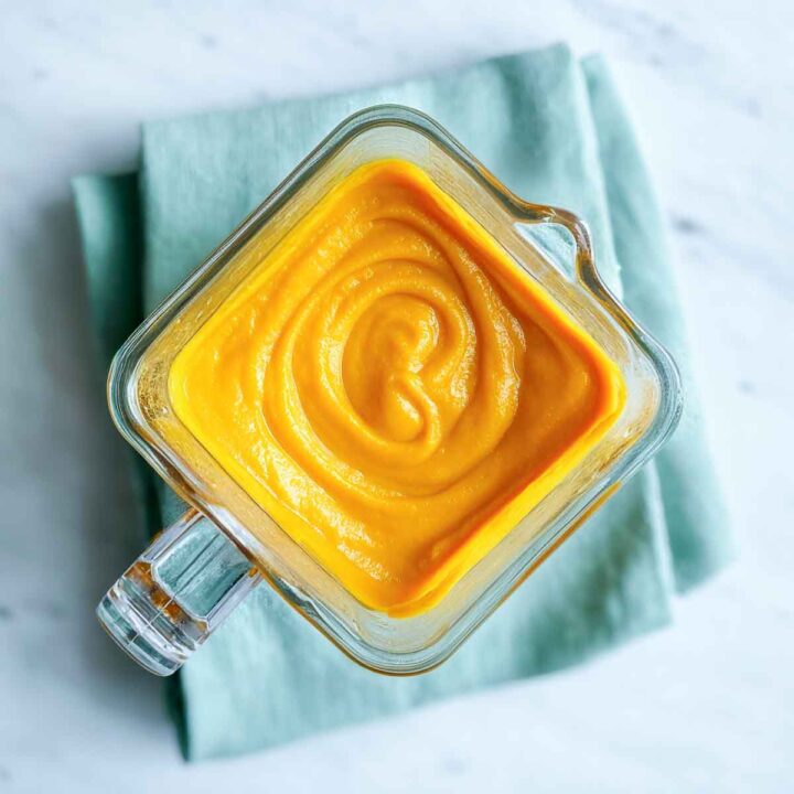 Smooth butternut squash purée in clear blender jar with visible texture.