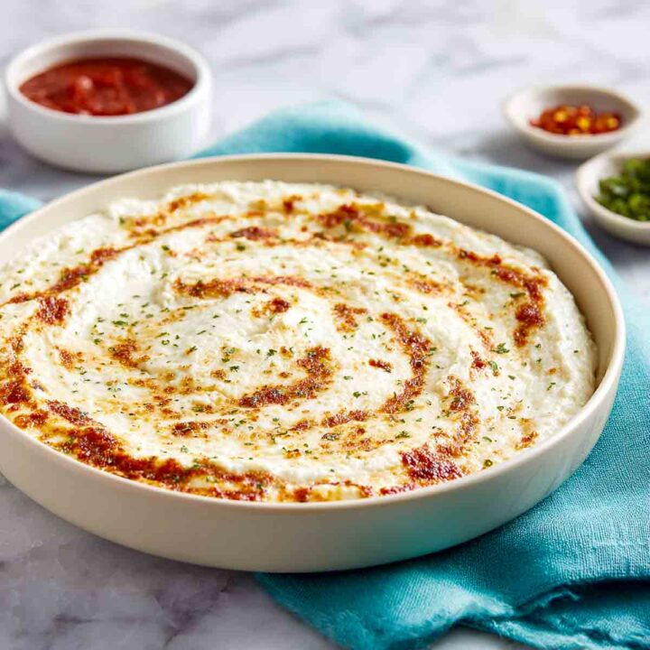 Freshly microwaved cottage cheese pizza base with lightly golden melted cheese.