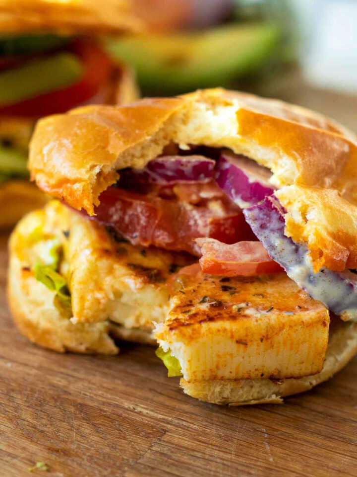 Close up of halloumi burger with a bite taken off.