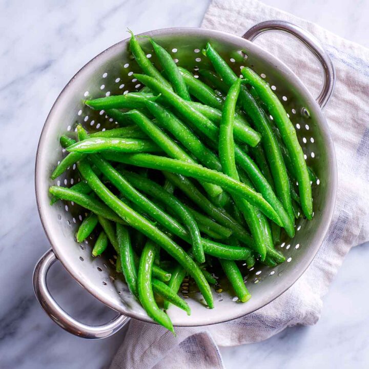 Blanched green beans drained in a colander and ready for the casserole.