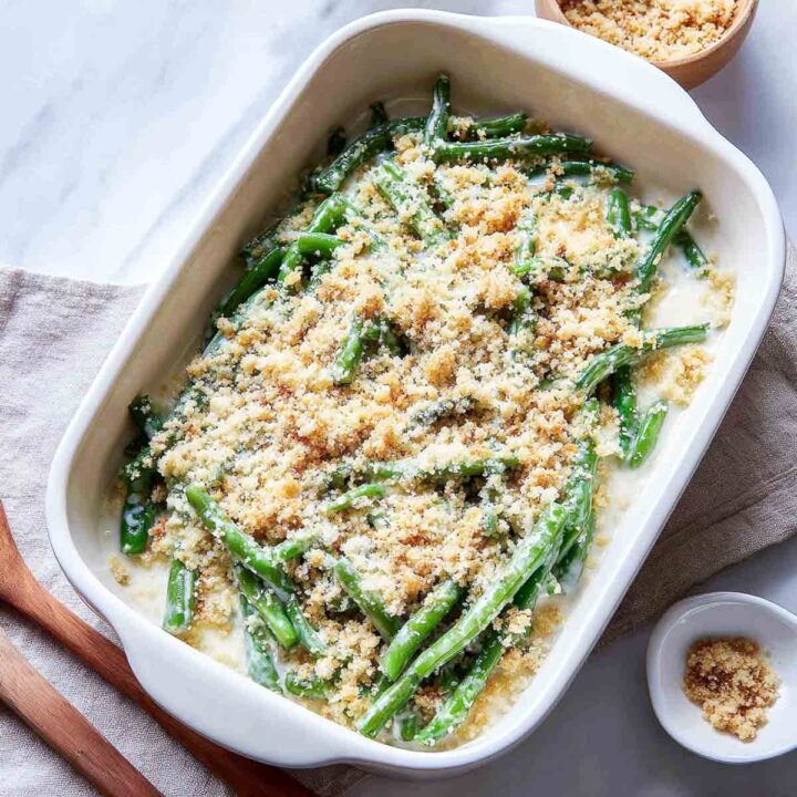 Unbaked casserole topped with pale garlic butter crumbs before baking.