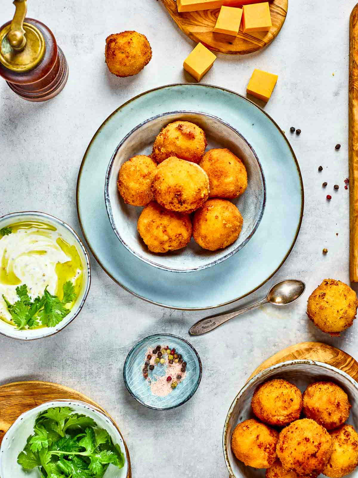 Top view of mac and cheese bites in a blue bowl.