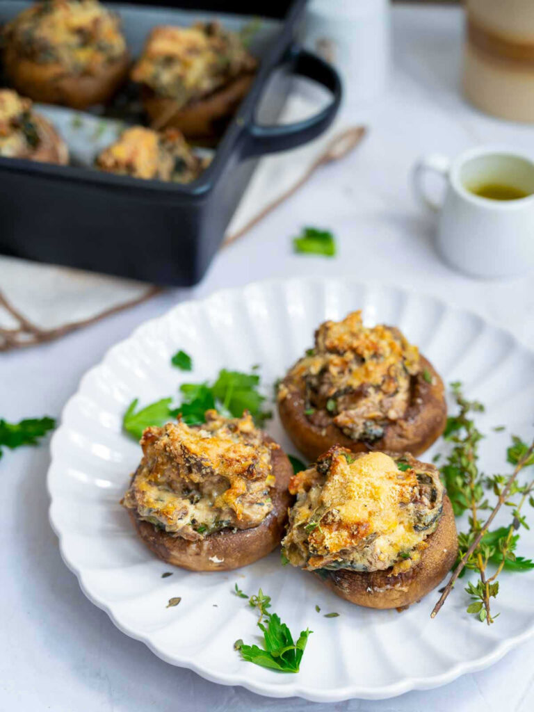 Mushrooms, generously filled with a savory stuffing with chopped mushroom stems and vegetables. The tops are nicely browned, by baking.
