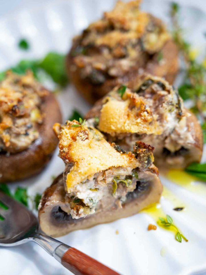 Close up of mushroom cut into half to show the filling.