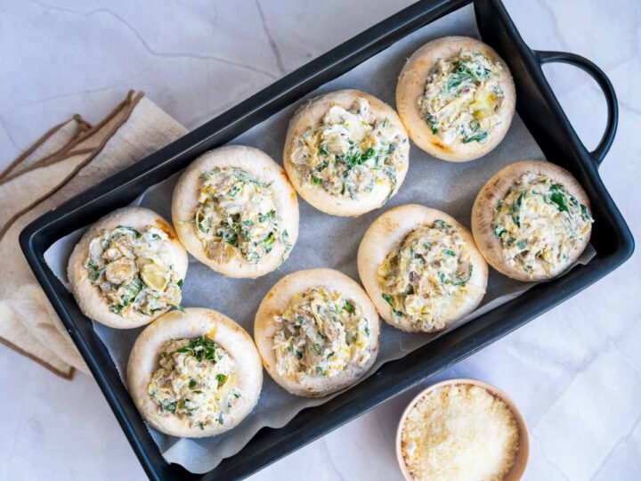 Cleaned mushrooms filled with stuffing and ready to be baked.