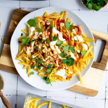 Top view of loaded Vietnamese fries served on a white plate.