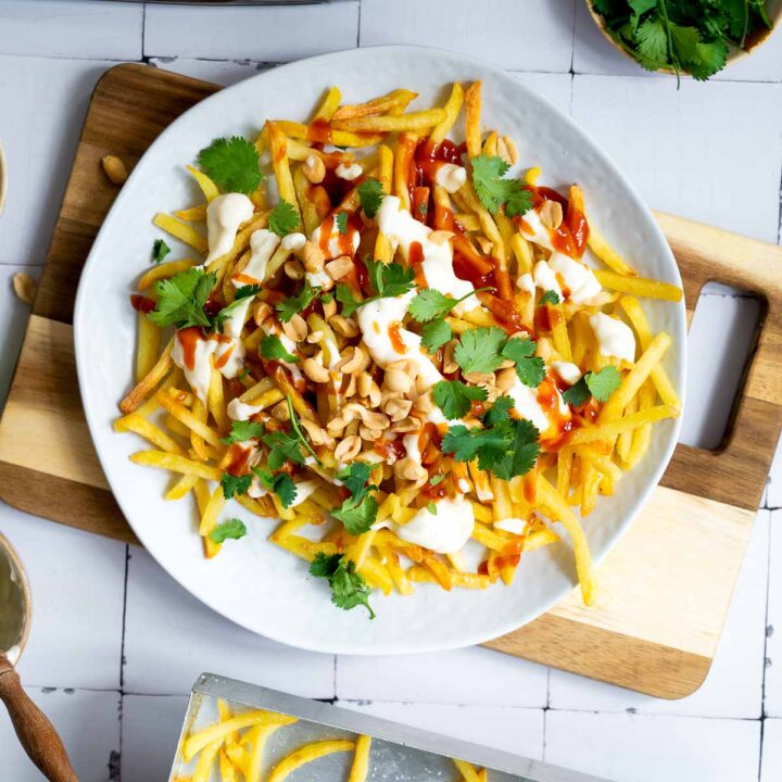 Top view of loaded Vietnamese fries served on a white plate.