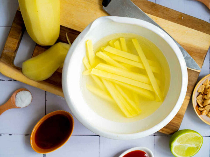 Potatoes peeled and cut, and soaked in cold water.