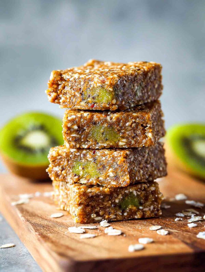 Baked almond butter kiwi snack squares cut into neat pieces and placed on a wooden board.