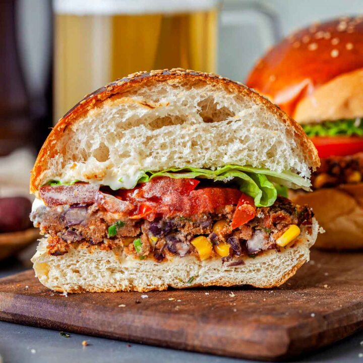 Vegan black bean burger sliced into half to show the interior.