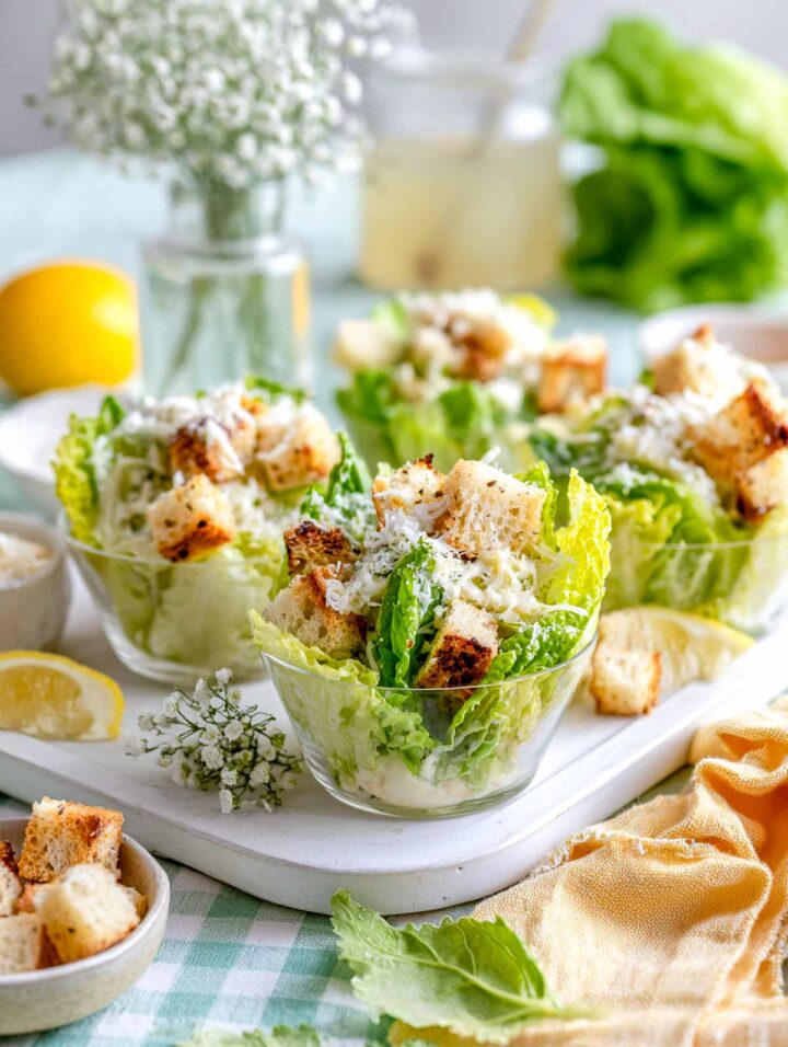 Mini Caesar salad cups with romaine lettuce, homemade croutons, and Parmesan.