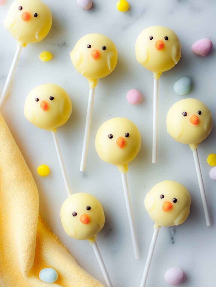 Top view of lemon cake pops decorated with yellow candy coating to resemble chicks.