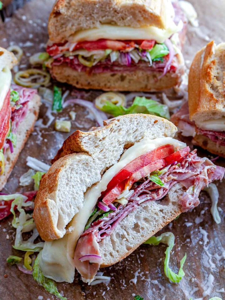 Sliced Italian grinders placed on a brown parchment paper.