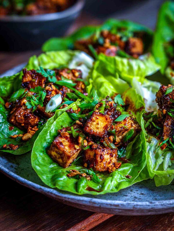 Crispy tofu pieces served in lettuce wraps with chili oil and fresh herbs.