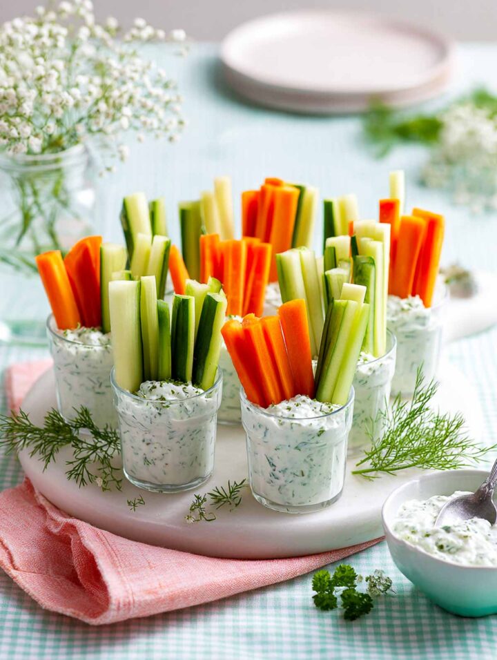 Veggie cups with creamy herb Greek yogurt dip and fresh vegetables.