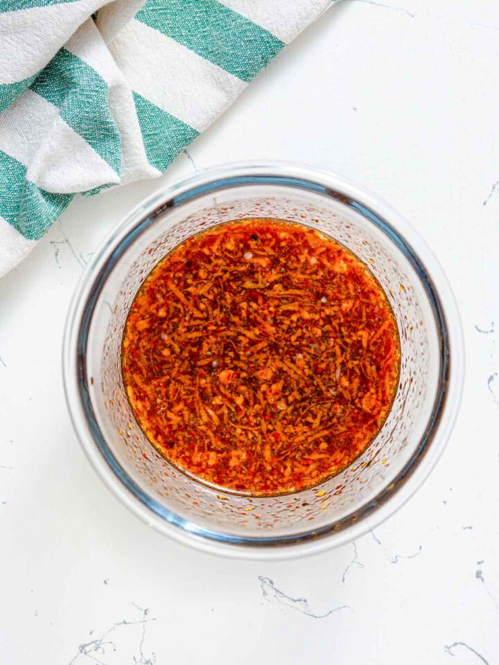 Bowl of homemade orange sauce with spices and zest mixed together.