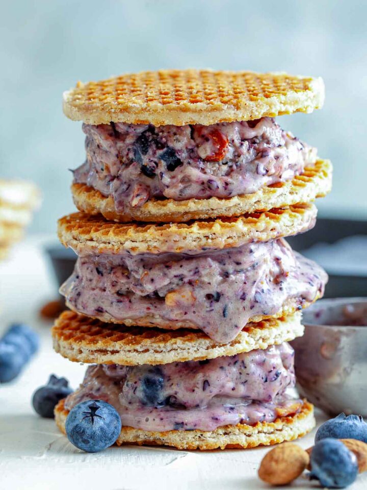 A stack of blueberry ice cream wafflewiches placed on a white board.