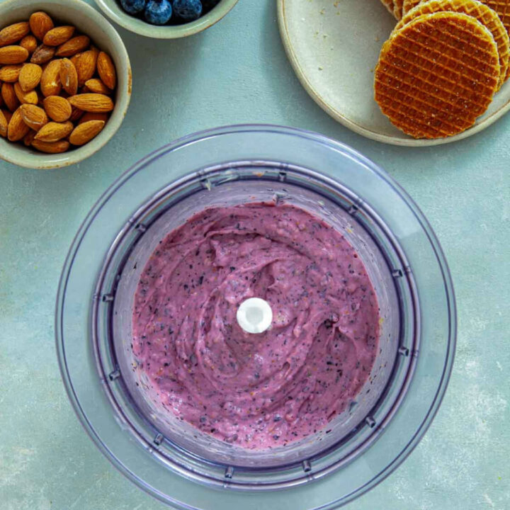Blueberry ice cream mixture blended in a food processor