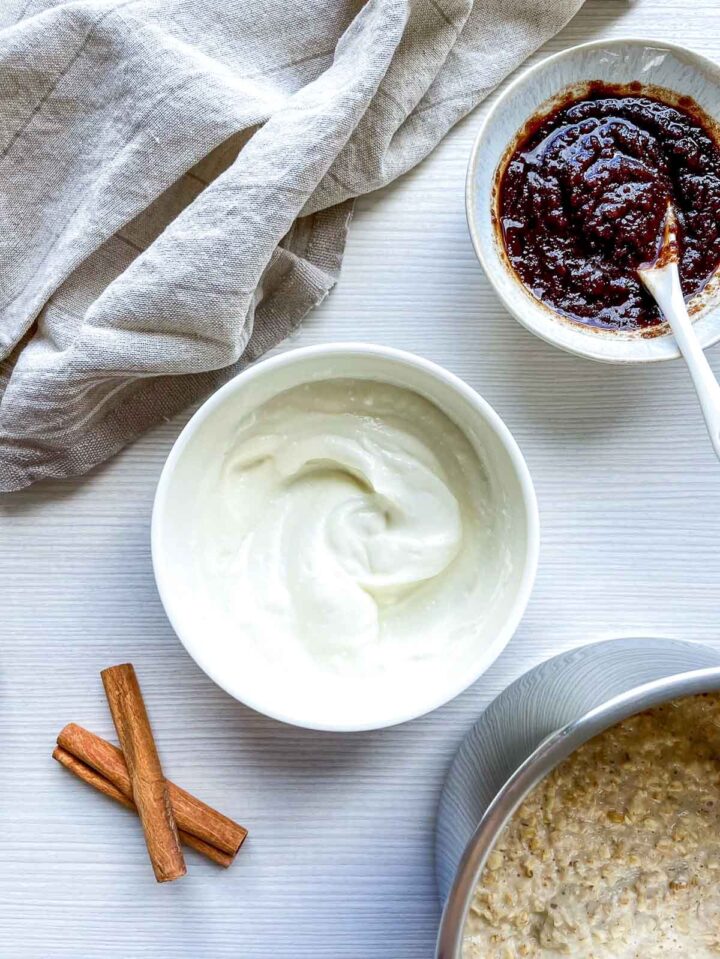 Creamy yogurt glaze and cinnamon mixture prepared for topping the oatmeal.