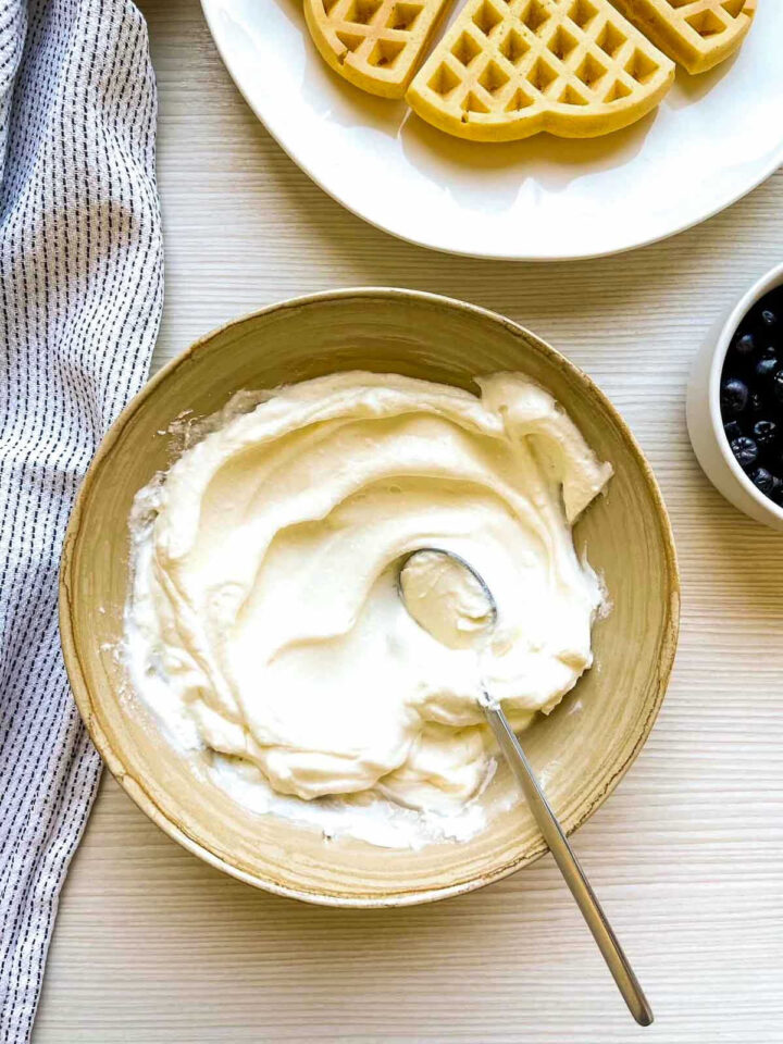 Creamy cheesecake-style topping mixed and ready to spoon over warm waffles.