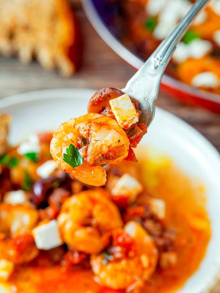 Close up of shrimp and feta scopped on a spoon.