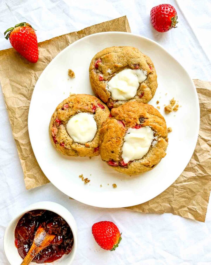 Strawberry cheesecake cookies with creamy centers on a white plate