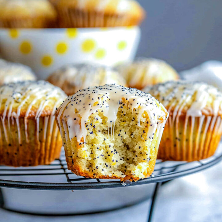 Lemon Poppy Seed Cupcakes with Zesty Glaze placed on a wire rack.