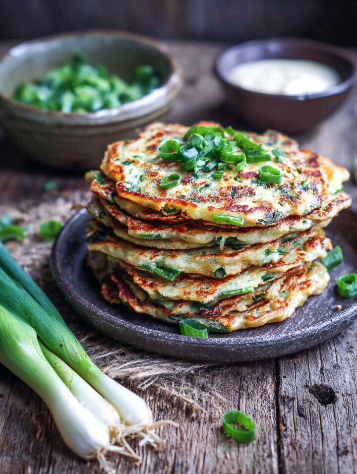 A stack of scallion pancakes placed on a grey plate.