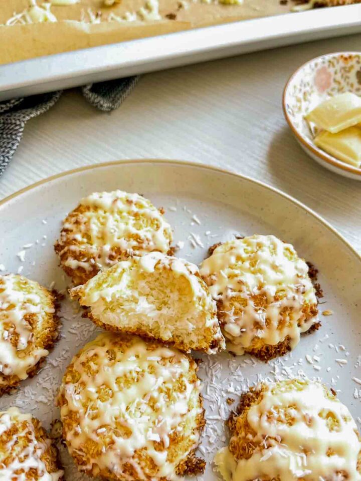 Coconut macaroon with a broken piece showing the soft center.