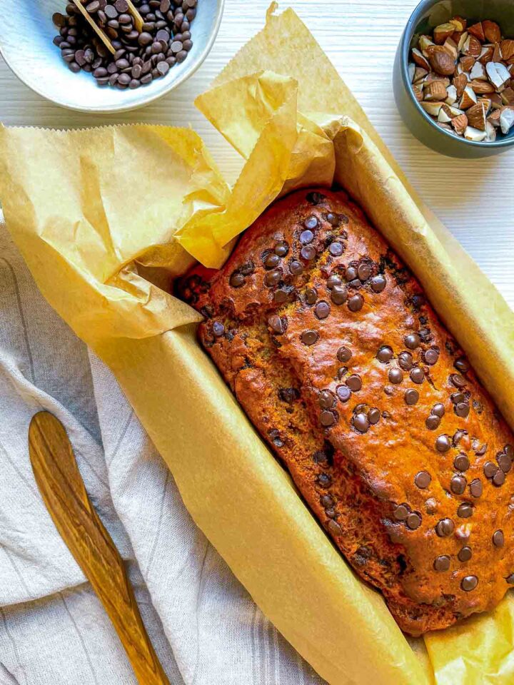 Golden-brown almond chocolate banana bread fresh from the oven, studded with melted chocolate chips and baked to a perfectly moist, tender finish.