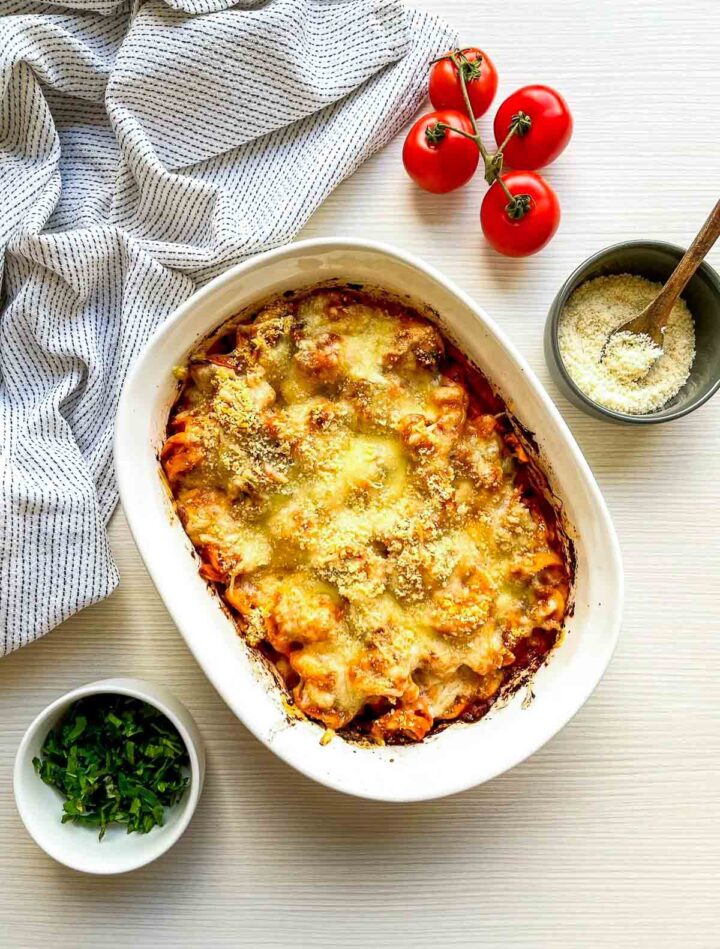 Freshly baked tortellini with bubbling, golden melted cheese and a rich tomato sauce, straight from the oven.