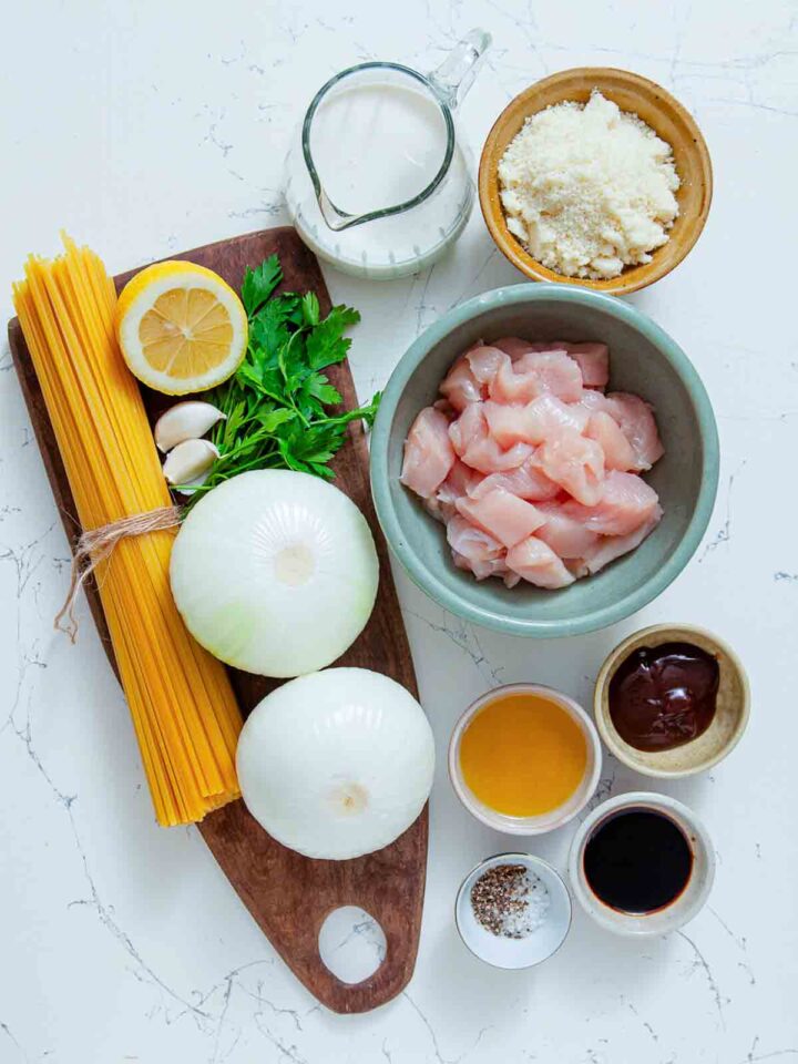 Simple ingredients for a creamy chicken linguine: pasta, chicken, onions, garlic, lemon, cream, cheese, herbs, and a few flavorful sauces and seasonings.