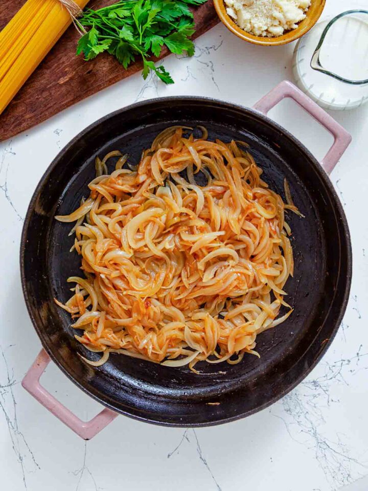 Onions are sautéed until soft and lightly caramelized, developing a sweet, rich flavor base.