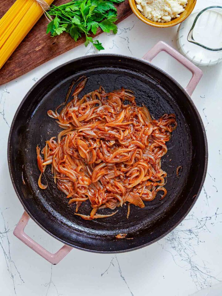Onions are cooked further until deeply caramelized, turning rich brown and intensely flavorful.