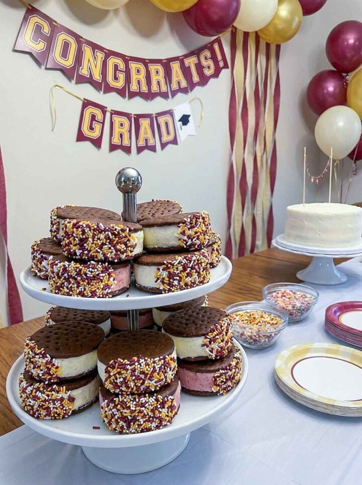 Ice cream sandwiches placed on a cake stand on the graduation party dessert table.