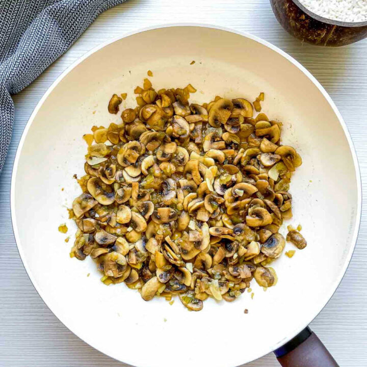 Sautéed mushrooms and onions cooking in a pan