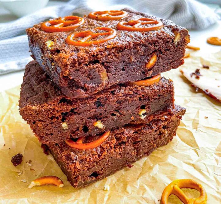 Stacked fudgy brownies with pretzels and powdered sugar