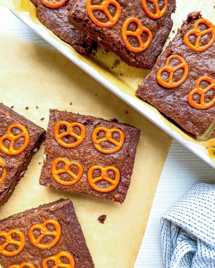 Cut brownie squares topped with mini pretzels