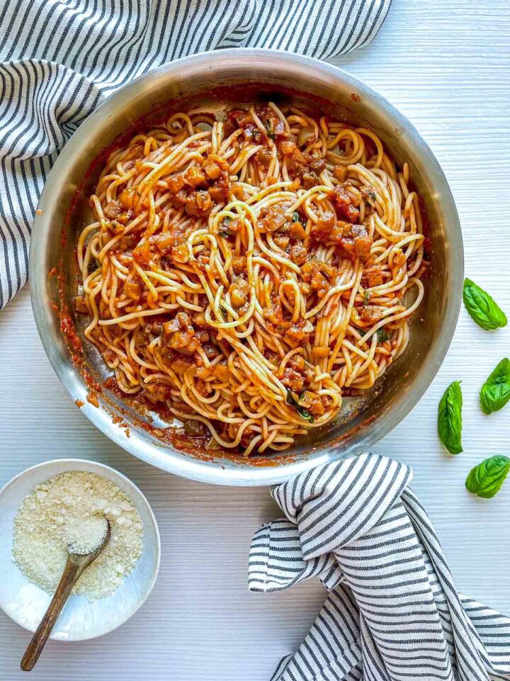 Spaghetti fully tossed in a rich eggplant tomato sauce, evenly coated and ready for serving.