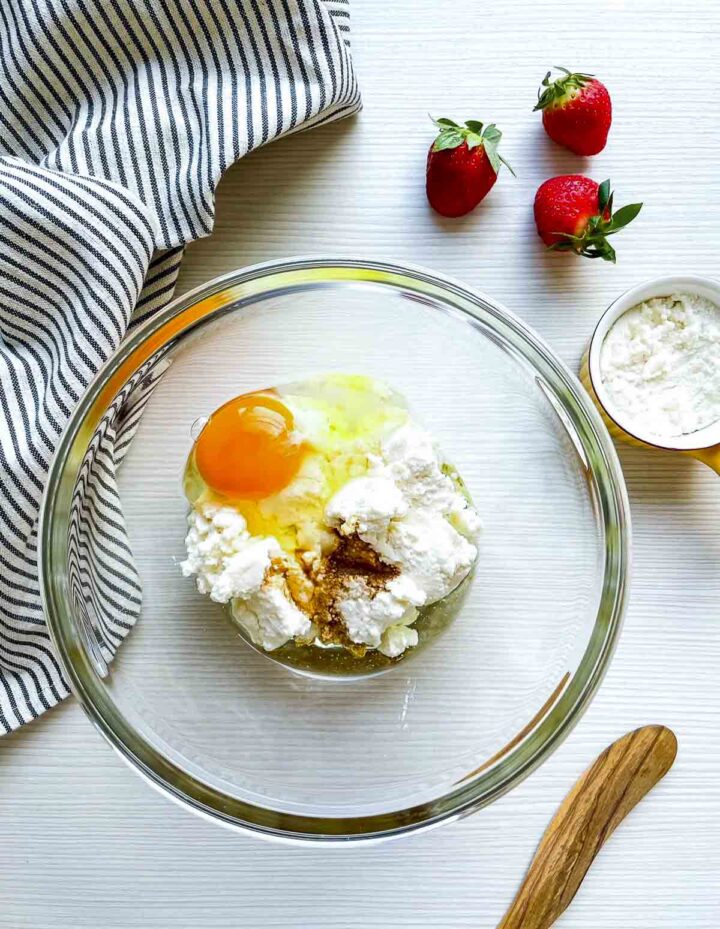 Egg, ricotta cheese, flour, and vanilla in mixing bowl