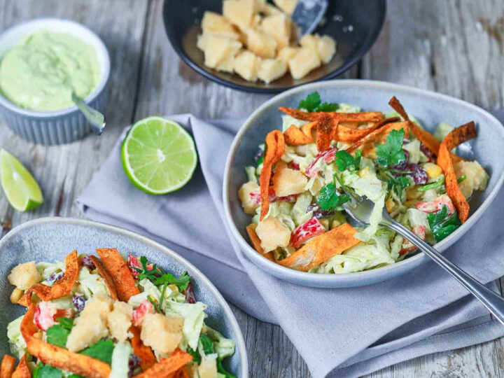 Close up of Mexican bean and corn salad served in a small grey bowl.