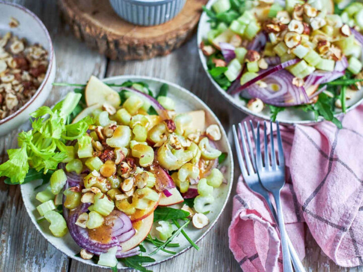An apple and celery salad topped with toasted hazelnuts